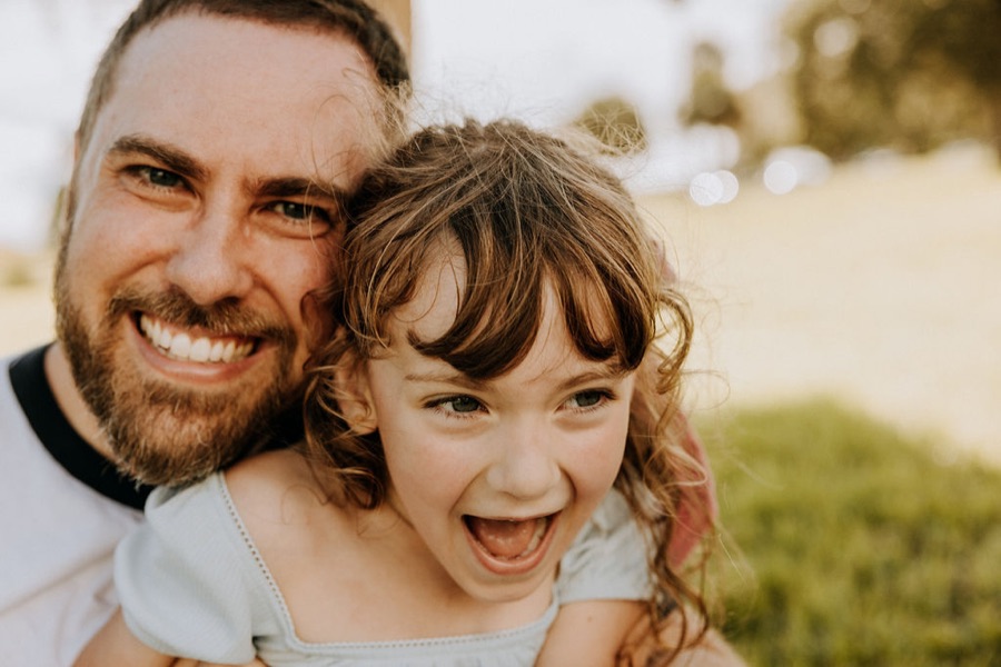 Aaron laughing with his daughter