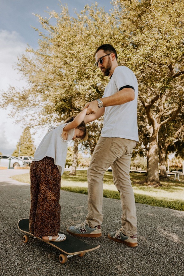 Aaron teaching his daughter to skateboard
