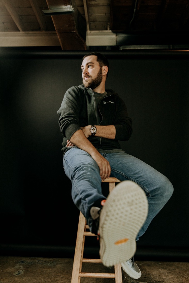 Aaron sitting on a stool