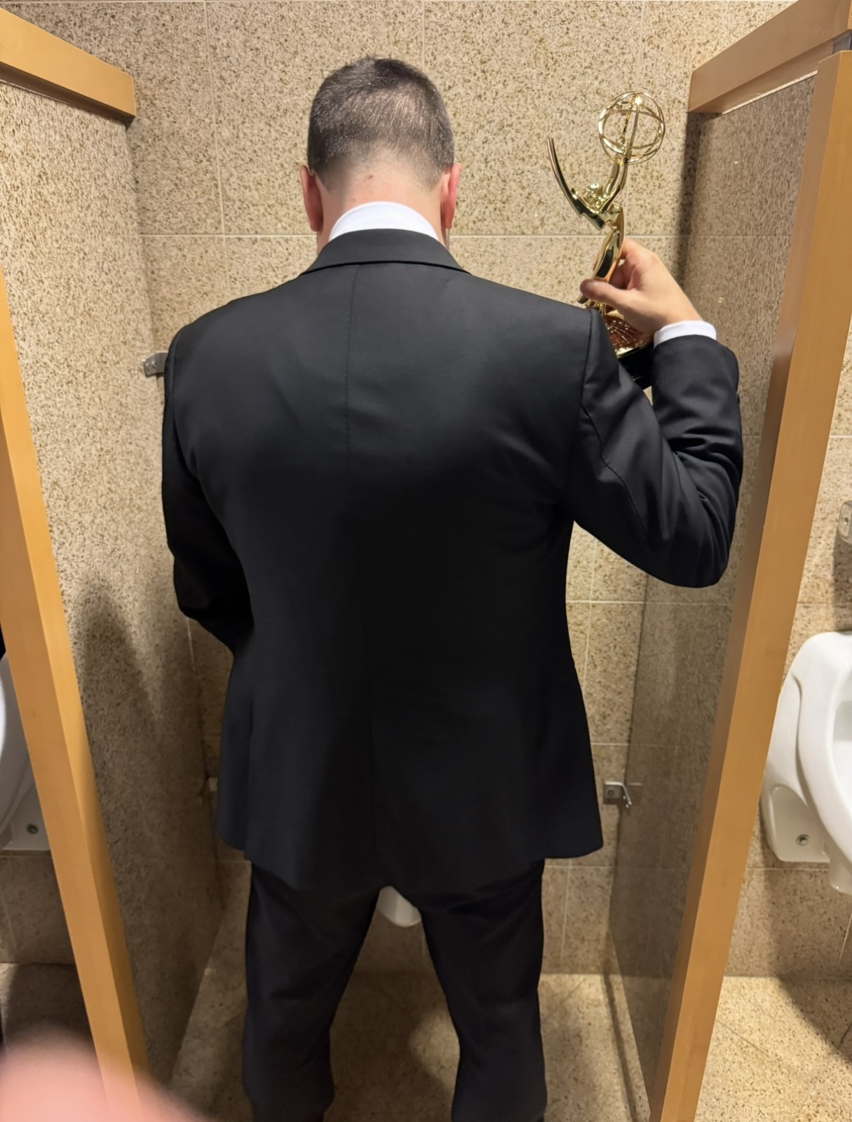 Not letting go of the Emmy, even in the restroom